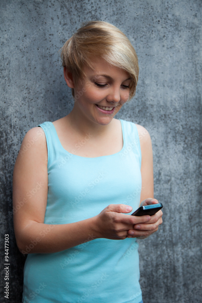 Fototapeta premium Attractive teenage girl using smart phone
