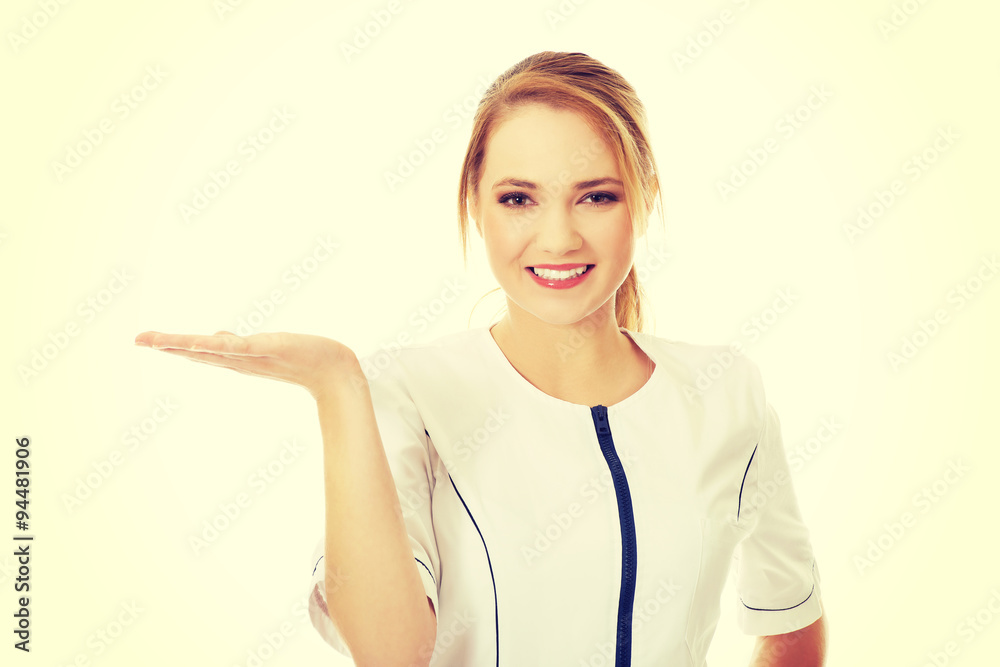 Young female doctor holding an abstract space. Young female doctor holding an abstract space.