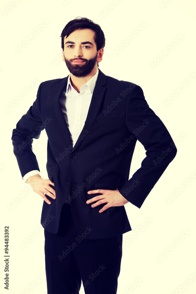Smiling businessman with hands on hips. Smiling businessman with hands on hips.