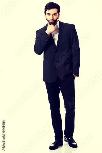 Young handsome businessman standing. © Piotr Marcinski