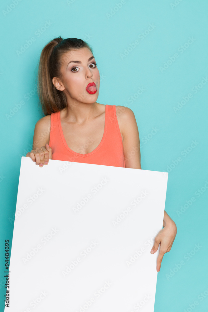 Girl Holding White Poster And Sticking Out Tongue Girl Holding White Poster And Sticking Out Tongue