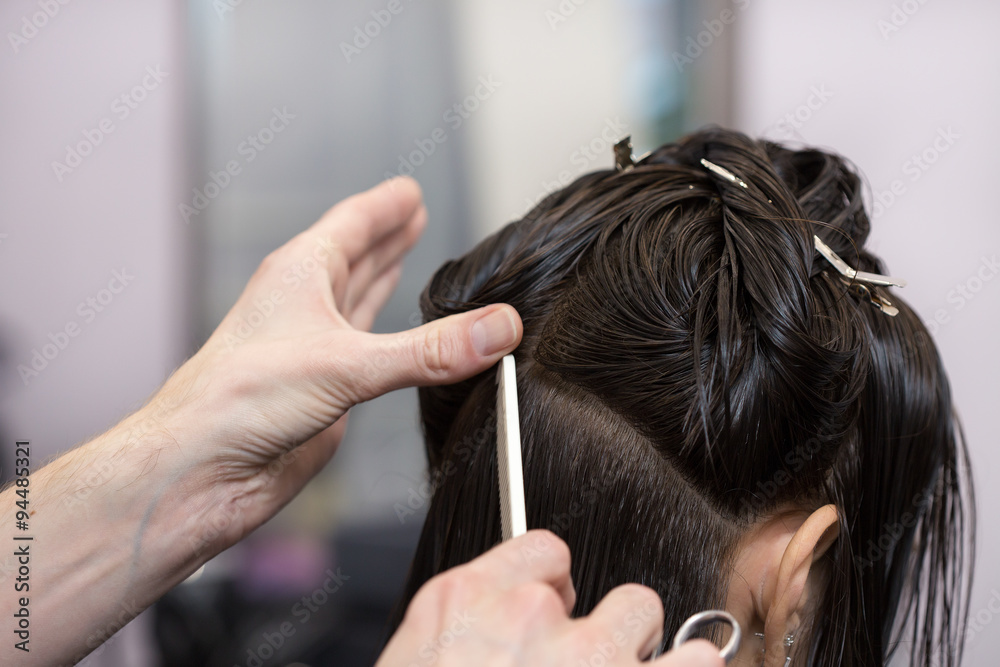 Fototapeta premium A brunette girl having her haircut