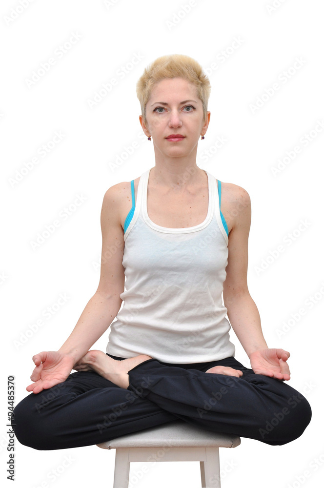 Woman with blonde short haircut sitting in lotus position on a stool