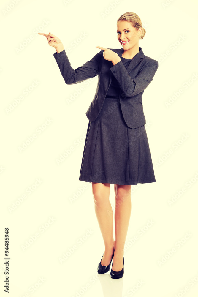 Businesswoman showing copy space on the left Businesswoman showing copy space on the left