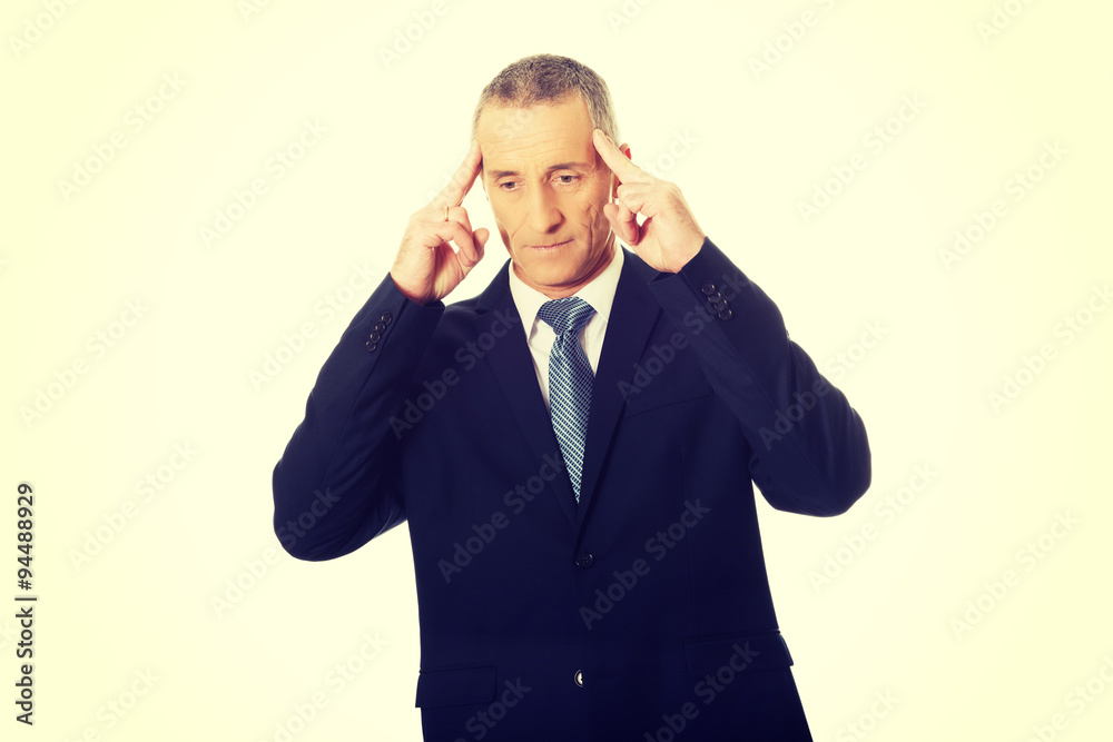 Pensive businessman touching head Pensive businessman touching head