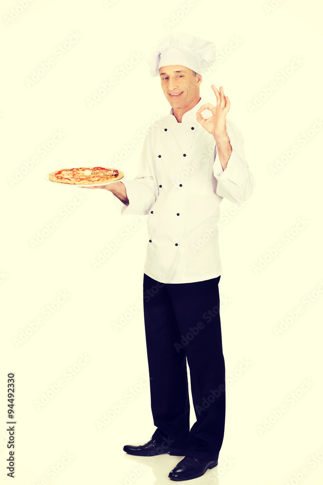 Chef baker with italian pizza showing perfect sign Chef baker with italian pizza showing perfect sign