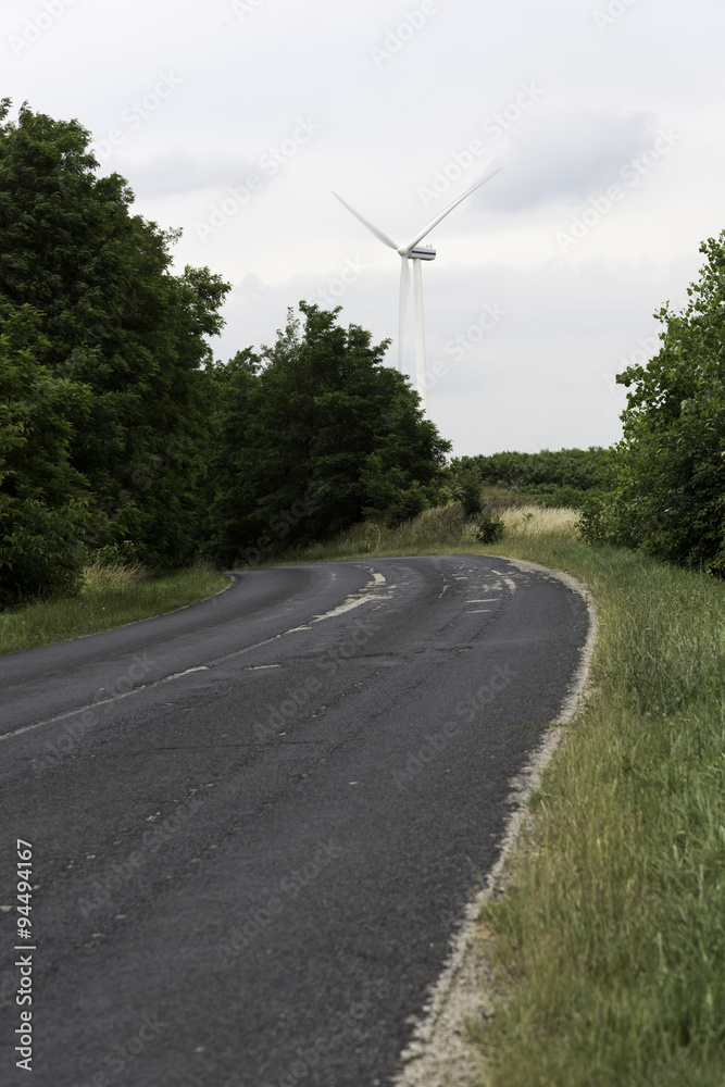 Power Generating Windmills and road
An asphalt road leading in the direction of a windmill (wind turbine).