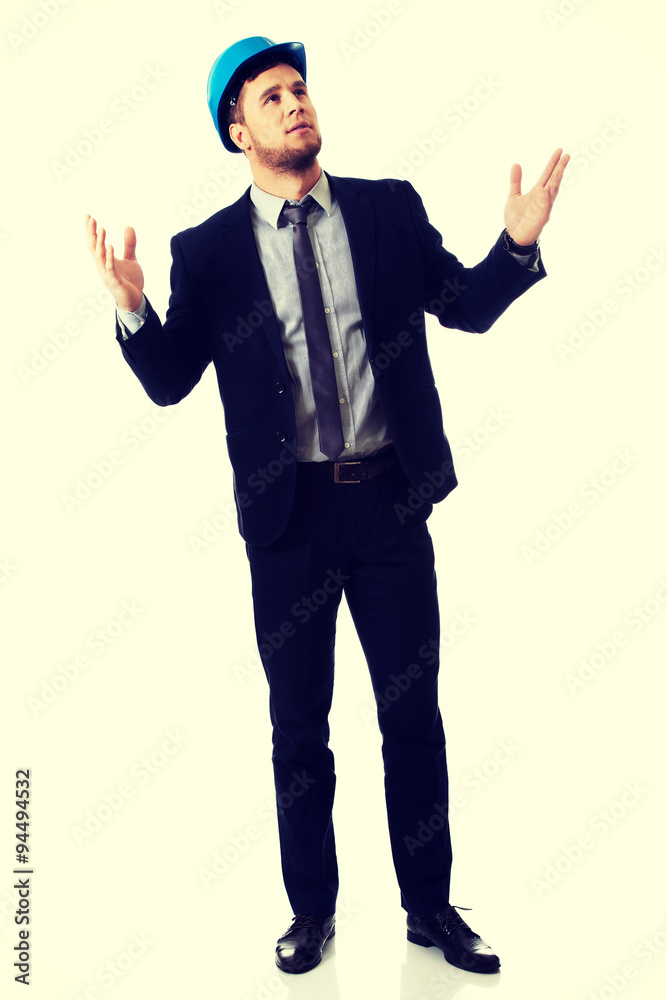Businessman in hard hat holding copyspace. Businessman in hard hat holding copyspace.