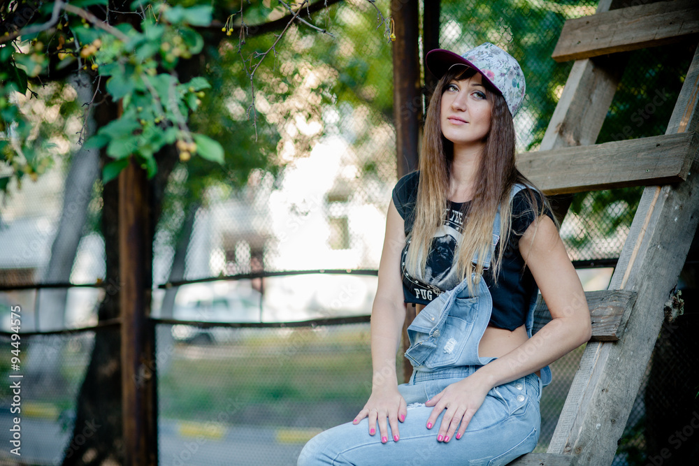 Naklejka premium beautiful girl in denim overalls