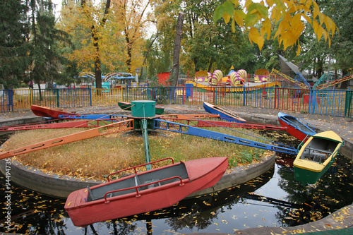 Children Children ride the boat in the autumn park. Nostalgia on