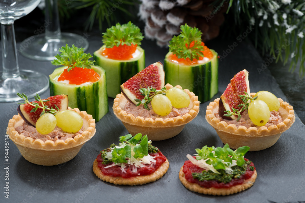 Set of festive Christmas mini appetizers on dark background Set of festive Christmas mini appetizers on dark background