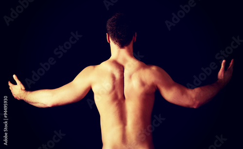 Sexy muscular man showing his muscular back. © Piotr Marcinski