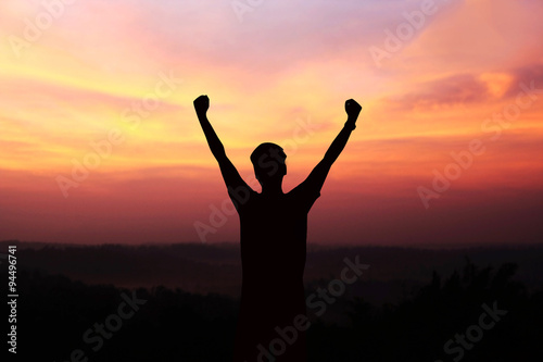 silhouette of man show arm up for achievements successful and ce