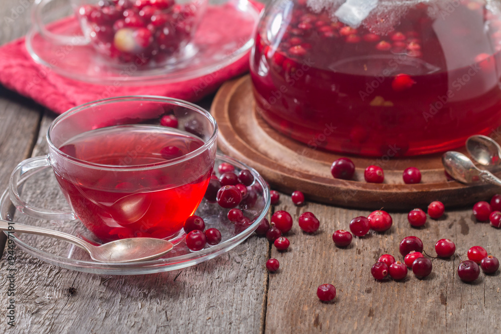 Cranberry tea in a glass cup and teapot Cranberry tea in a glass cup and teapot