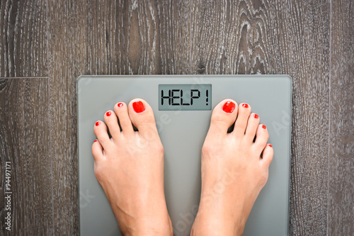 Lose weight concept with person on a scale measuring kilograms photo