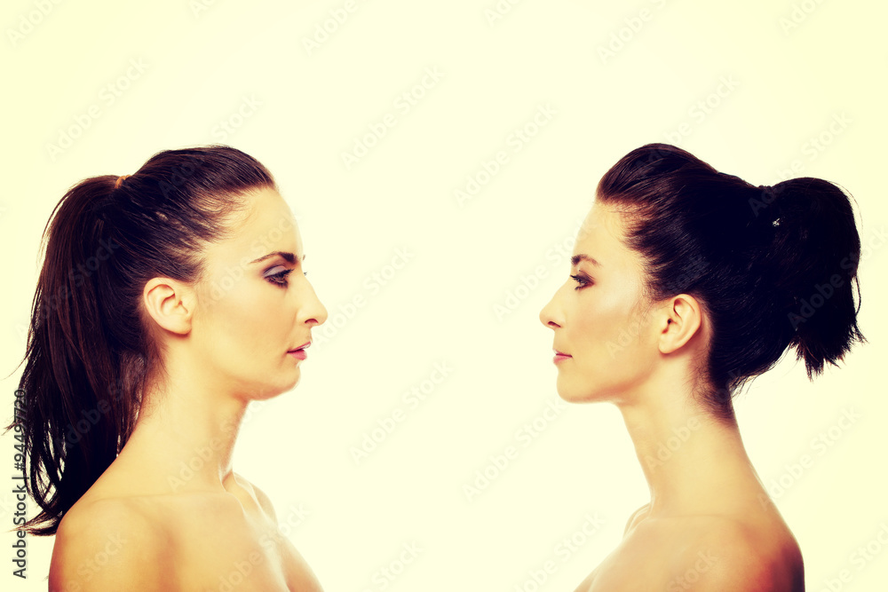 Two sisters standing face to face. Two sisters standing face to face.
