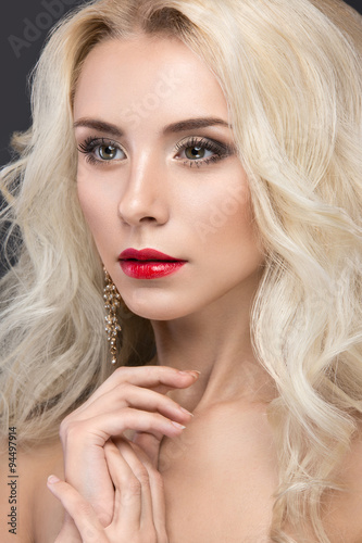 Fotografie Beautiful blond woman with evening make-up, red lips and curls