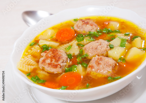Soup with meatballs, farfalle pasta and vegetables