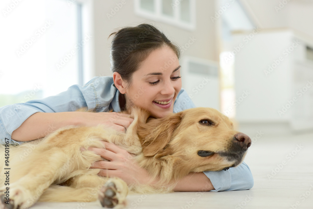 Young woman petting her dog