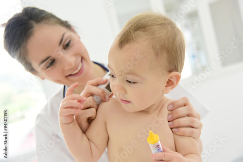 Pediatrician taking baby s temperature
