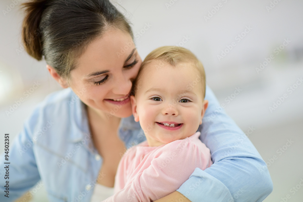 Portrait of mother cuddling her baby Portrait of mother cuddling her baby