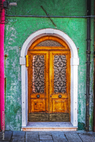 wooden door in a green rustic wall in Burano © Gabriele Maltinti