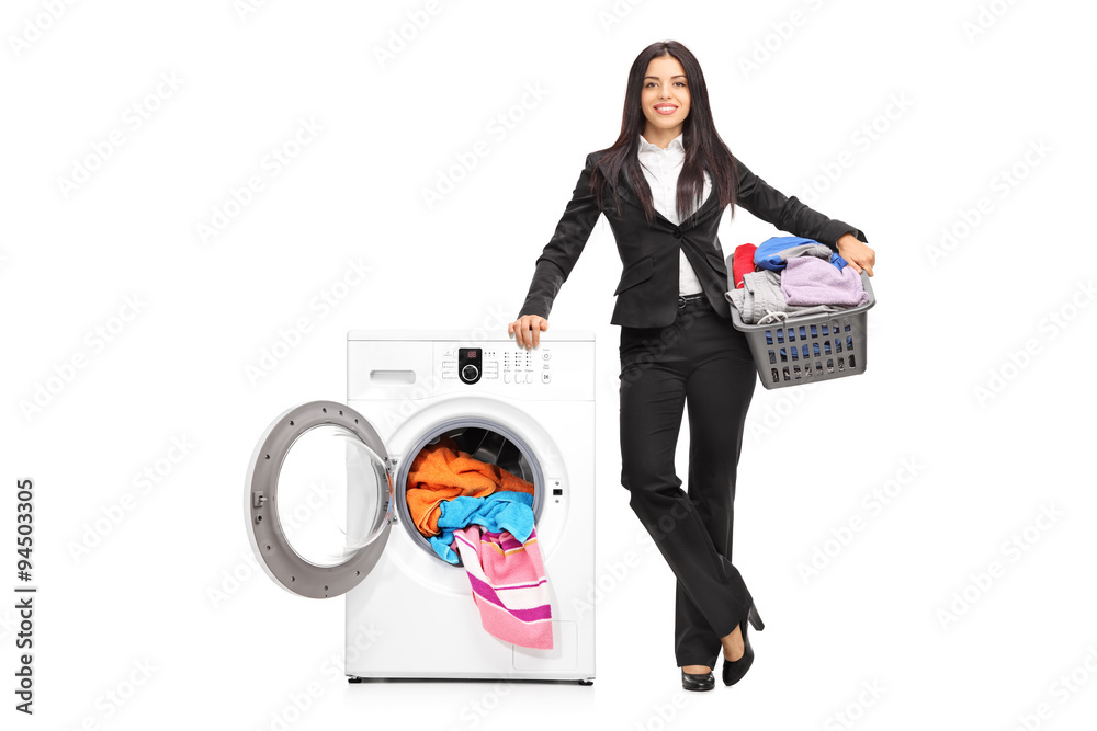 Businesswoman standing by a washing machine