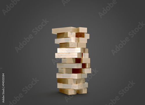 Blocks wood game jenga on black background.