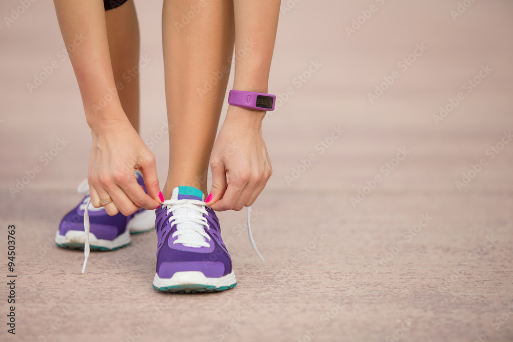 Woman tying sports shoe