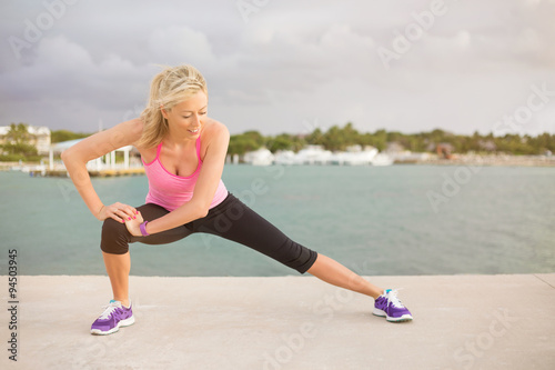 Runner stretching outdoors in early morning
