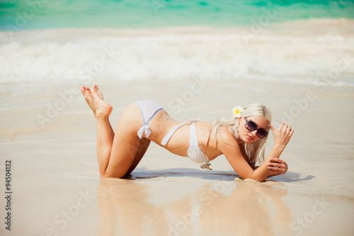 Photography stylish sexy blonde lying on the beach