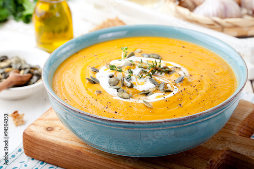 Roasted pumpkin and carrot soup with cream . 