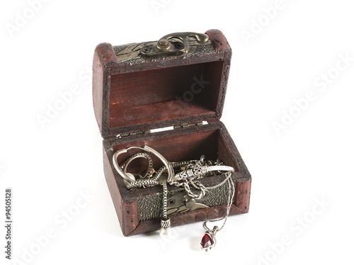 Wooden jewerly box with silver necklaces and earrings isolated