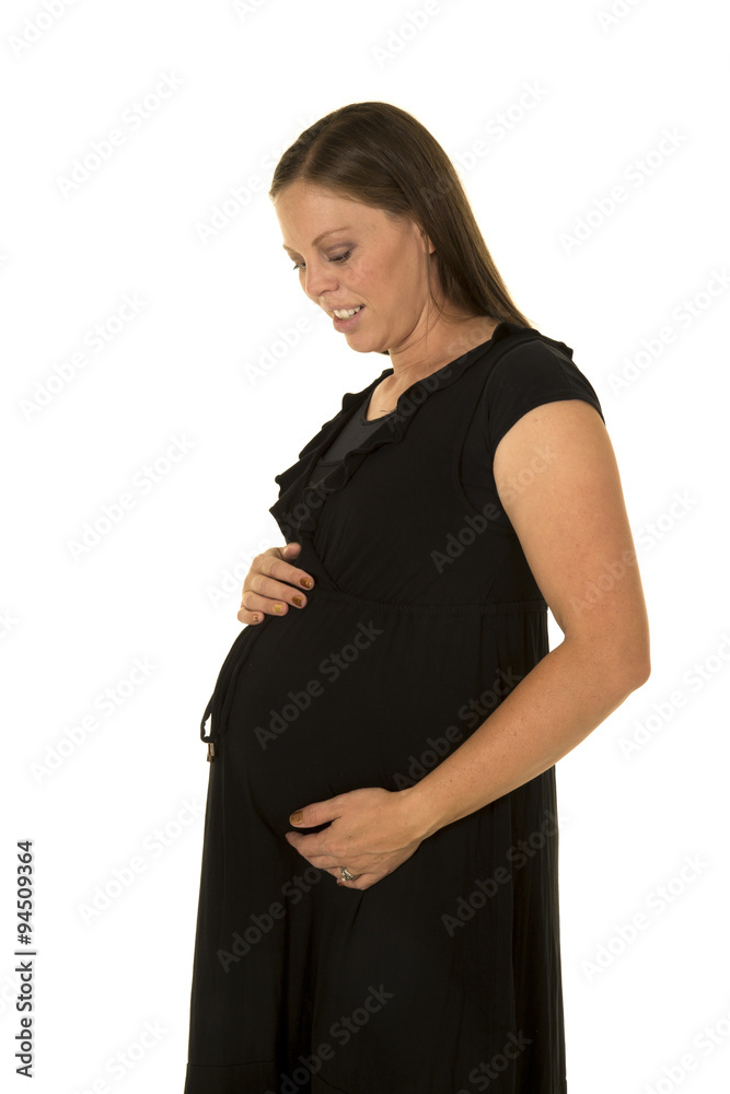 pregnant woman in black dress stand look down pregnant woman in black dress stand look down