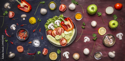 Ingredients for cooking variety of fruit vegetables apple peppers mushrooms seasoning oil salt on a long two-tone table in the pan on rustic wooden background top view