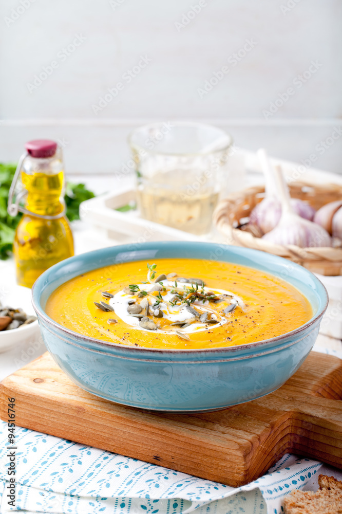 Roasted pumpkin and carrot soup with cream . 
