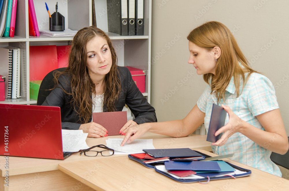 Girl shows resume employer, the employer wary looks at her Girl shows resume employer, the employer wary looks at her