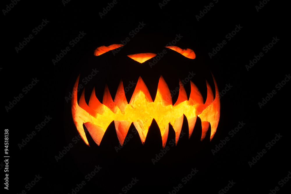 Spooky pumpkin in dark, isolated on black background
