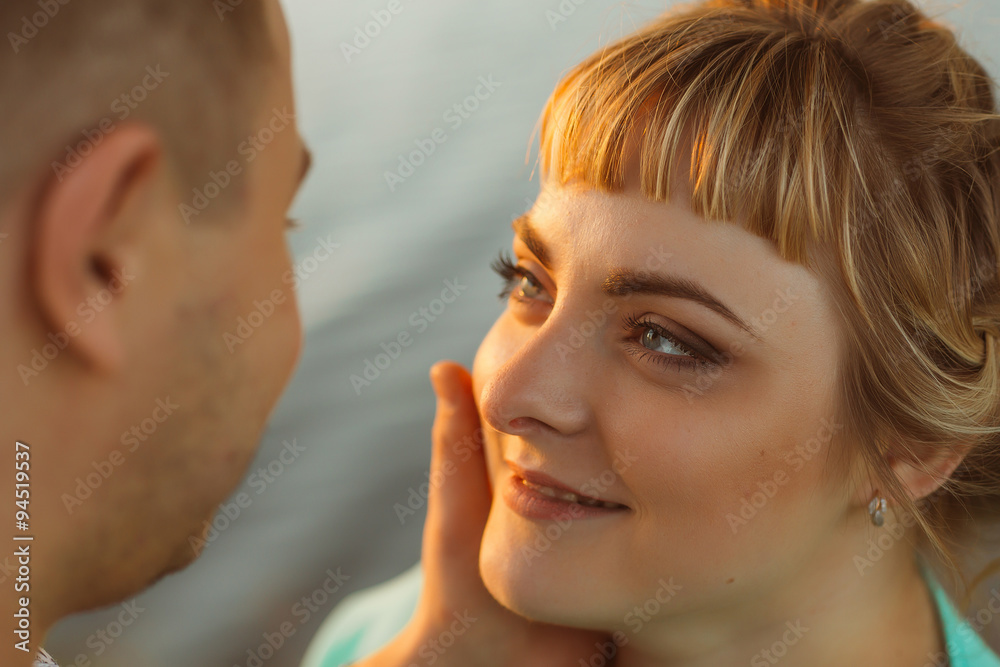 Romantic couple standing and kissing on background summer lake sunset Romantic couple standing and kissing on background summer lake sunset