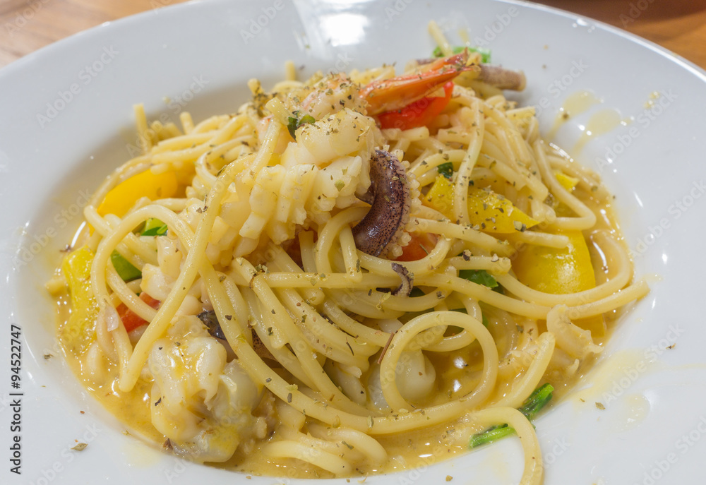Spaghetti carbonara with shrimp and squid