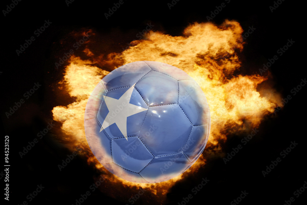 Fototapeta premium football ball with the flag of somalia on fire