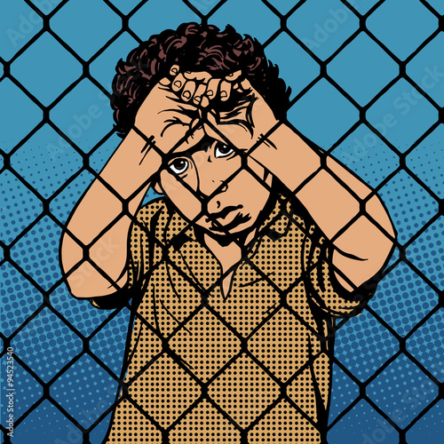 Child boy refugee migrants behind bars the prison boundary