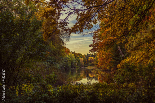 A fairytale pond surrounded by the colorful autumn trees