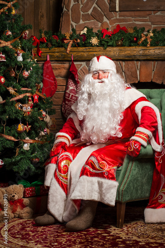 Cheerful Santa Claus sitting at his chair