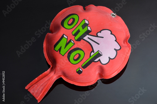 red whoopee cushion with reflection on black glass photo