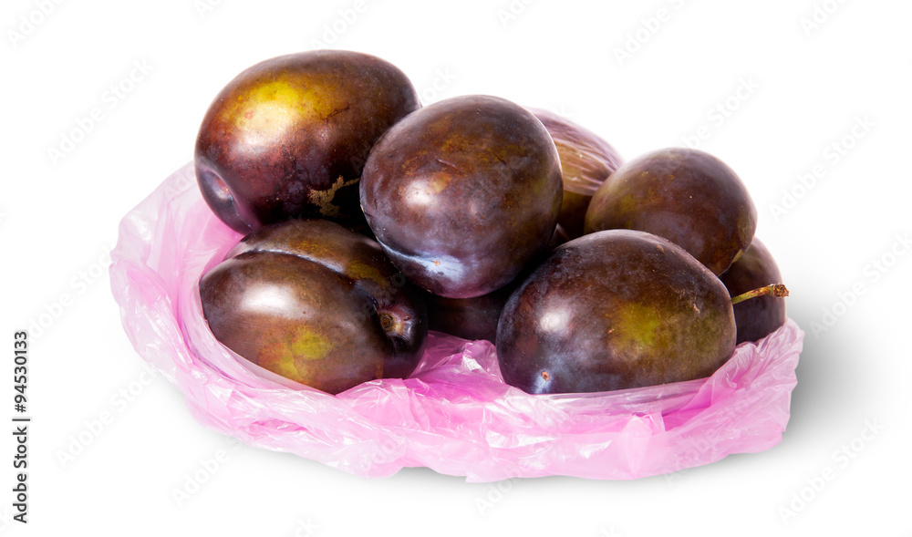 Obraz premium Whole violet plums in plastic bag