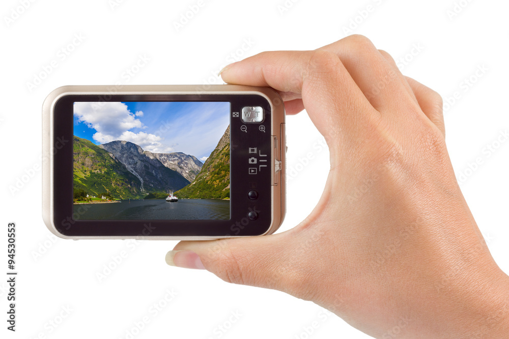 Hand with camera and Norway travel photo Hand with camera and Norway travel photo