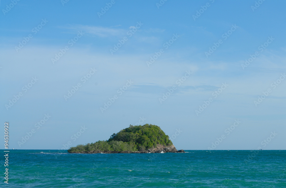 Small green island and sea with blue sky