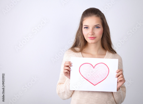 Portrait of young beautiful woman showing gift card. Valentines Day