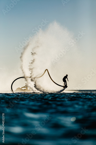 Silhouette of a fly board rider